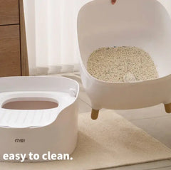 Modern white cat litter box with easy-clean design and wooden legs, ideal for stylish pet homes
