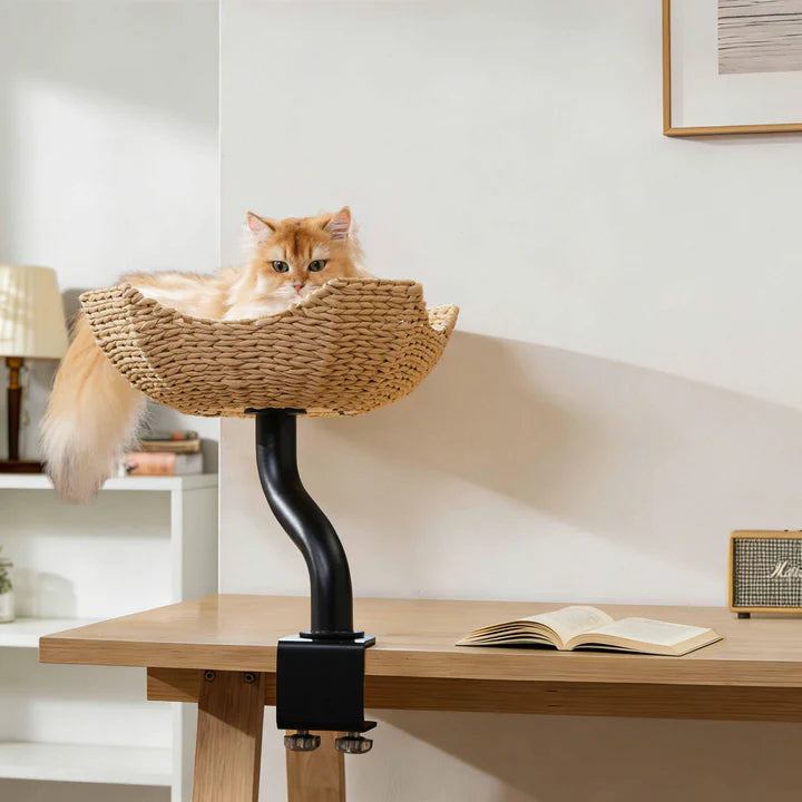 Michu DeskMate Desk-Mounted Cat Tree Perfect For WFH with a cat lounging comfortably on a woven perch above a desk.