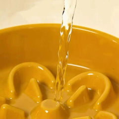Water pouring into yellow ceramic pet water fountain for cats and dogs