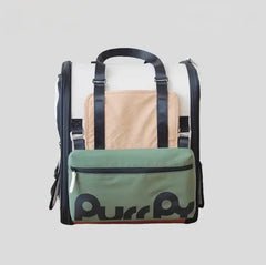 Purr Purr cat carrier backpack with green front pocket, beige mesh panel, and black straps for pet travel