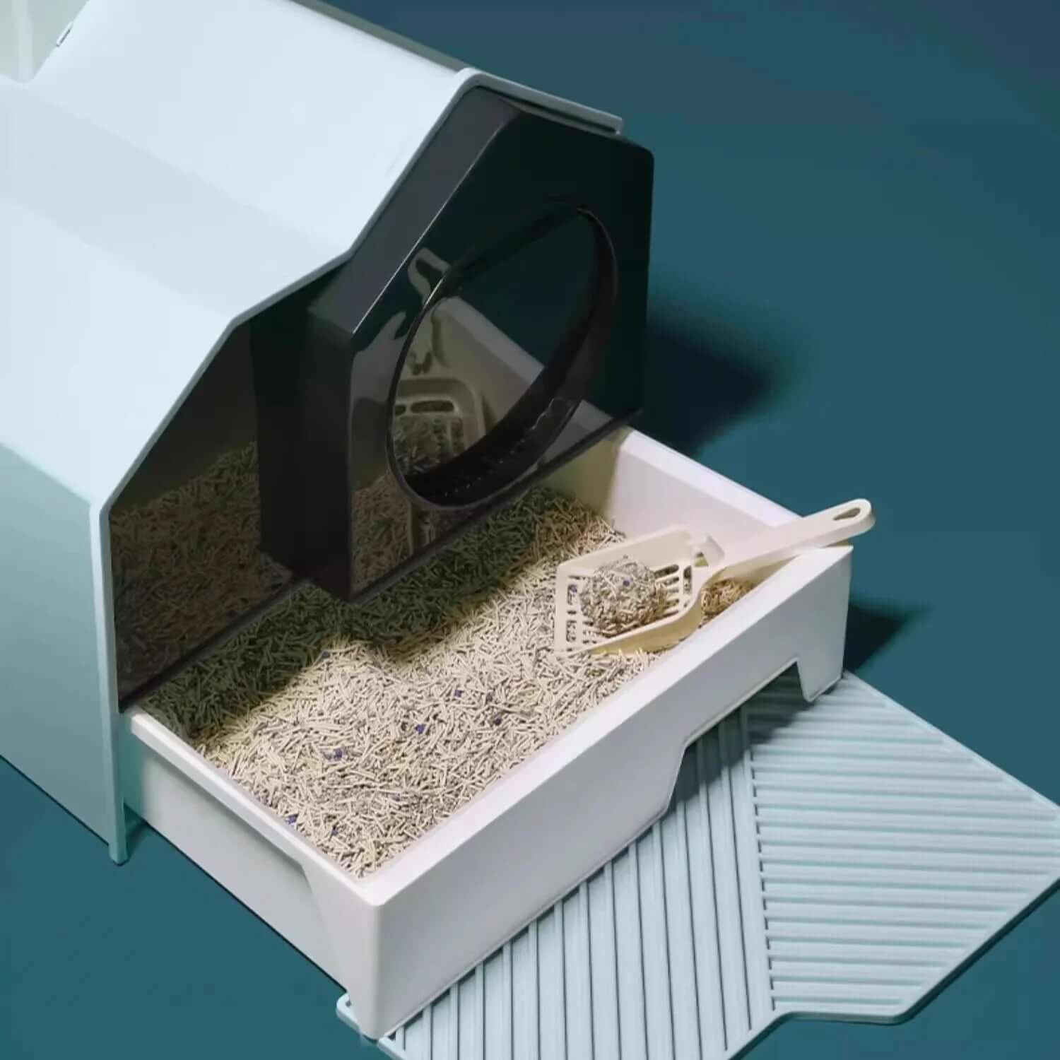Modern enclosed cat litter box with scoop and litter, ideal for indoor cats and clean pet care