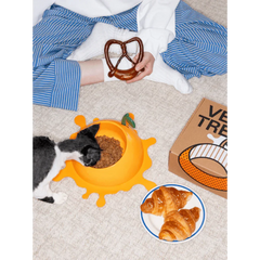 Vetreska Juicy Orange Pet Bowl & Spoon & Mat Set with cat eating from bowl and croissants nearby.